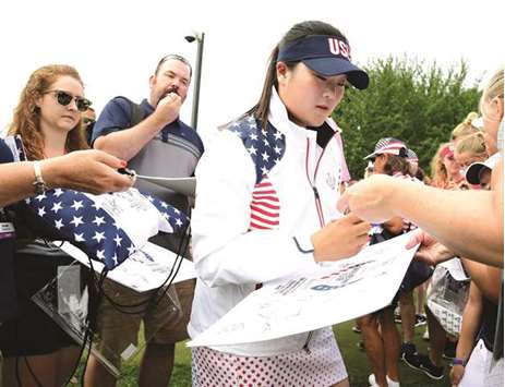 Angel Yin of Team USA signs autographs during practice for the Solheim Cup at the Des Moines Golf and Country Club in West Des Moines, Iowa.
