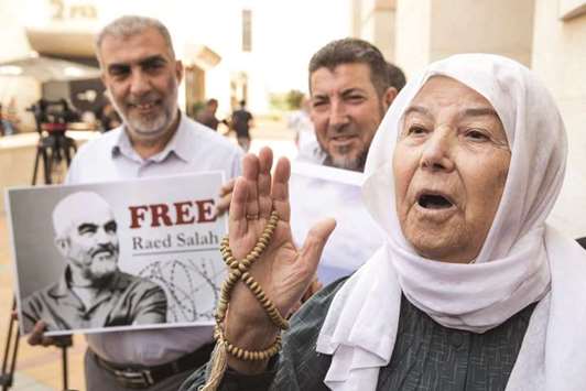 Arab-Israeli supporters of Sheikh Raed Salah protest against his arrest and detention outside the Israeli court yesterday.