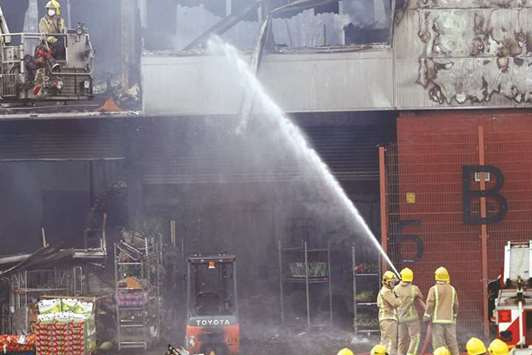 Firefighters spray water on a fruit market in Glasgow yesterday.