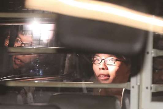 Student leader Joshua Wong leaves the High Court in a prison van after his sentencing on charges related to the 2014 pro-democracy Umbrella Movement, also known as Occupy Central protests, in Hong Kong, yesterday.