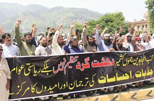 People hold a banner as they chant slogans in support of Hizbul Mujahideen group during a rally in Muzaffarabad, the capital of Pakistan-administered Kashmir, yesterday. The banner reads, u201cHizbul Mujahideen is not a terrorist group u2013 it represents the emotions and  feelings of the people of the state and a centre of hope.u201d
