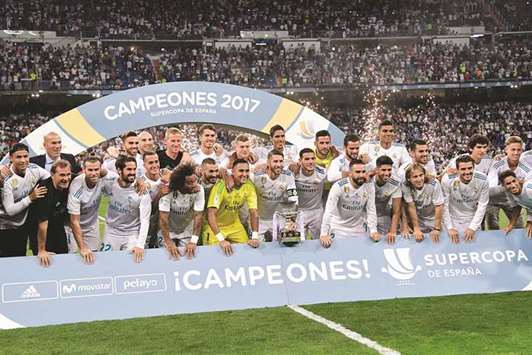 Real Madrid players celebrate winning the Super Cup after beating Barcelona at the Santiago Bernabeu stadium in Madrid on Wednesday. (AFP)