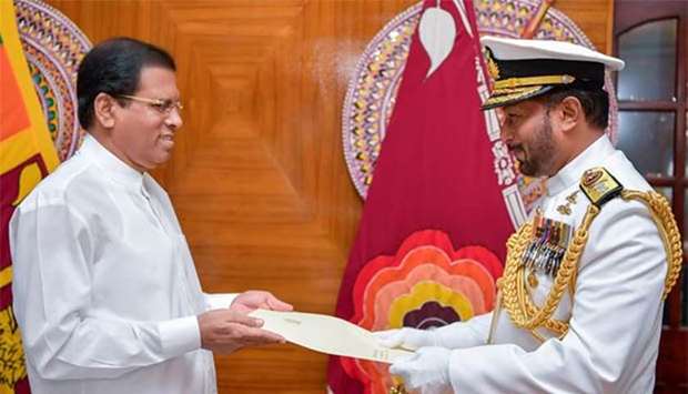 Sri Lankan President Maithripala Sirisena swears in the new Navy commander Rear Admiral Travis Sinniah in Colombo.