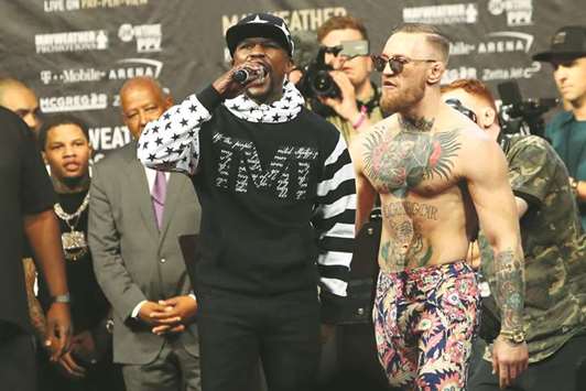 Floyd Mayweather (left), who has not fought in nearly two years, needs a win next week to surpass Rocky Marciano's record and reach 50-0 for his career, while Conor McGregor, who is making his professional boxing debut, is 21-3 in mixed martial arts.