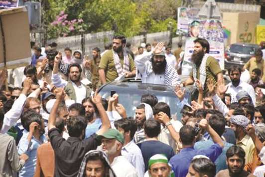 Syed Salahuddin, supreme commander of Hizbul Mujahideen, waves to supporters as he arrives to speak at a rally in Muzaffarabad, in this July 8, 2017 picture.