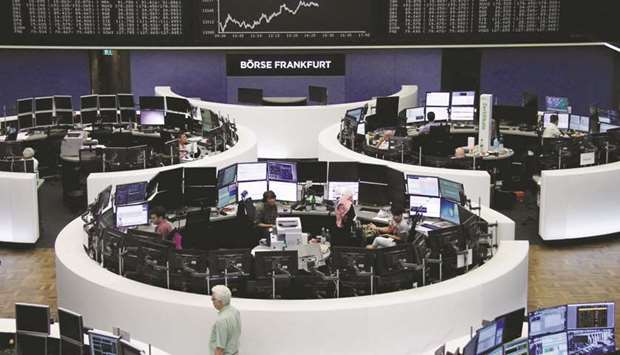 Traders are seen at the Frankfurt Stock Exchange. The DAX 30 lost 0.3% to 12,165.19 points yesterday.