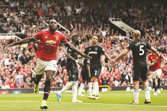 Manchester Unitedu2019s Belgian striker Romelu Lukaku (L) celebrates scoring his teamu2019s second goal during the English Premier League football match between Manchester United and West Ham United at Old Trafford  on August 13.