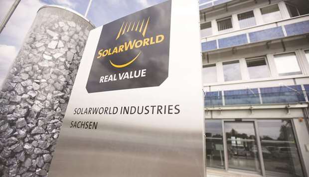 A display pillar of silicon rocks stands beside the Solarworld logo outside the photovoltaic cell factory in Freiberg, Germany. Solarworld founder Frank Asbeck and Qatar Solar Technologies took a 51% and 49% stake respectively in the new venture, Solarworld Industries, according to a statement on its website.