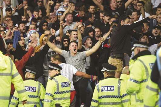 Hajduk Split supporters are held back by police and stewards after their side conceded the opening goal during the UEFA Europa League playoff round first leg match against Everton at Goodison Park in Liverpool, north west England, on Thursday. (AFP)