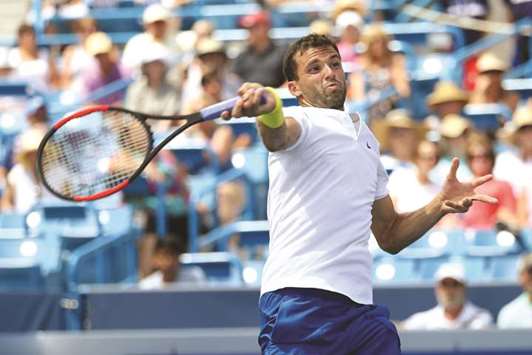 Grigor Dimitrov of Bulgaria returns a shot to Juan Martin Del Potro of Argentina in their Western and Southern Open match at the Linder Family Tennis Center in Mason, Ohio, on Thursday. (AFP)