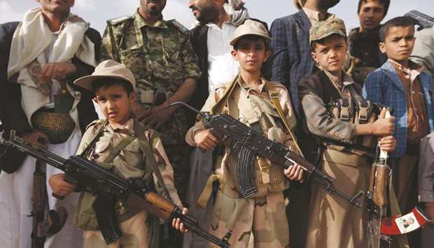 Yemeni children carrying weapons as they take part in a gathering organised by Houthi rebels to mobilise more fighters to battlefronts to fight pro-government forces in the capital Sanaa.