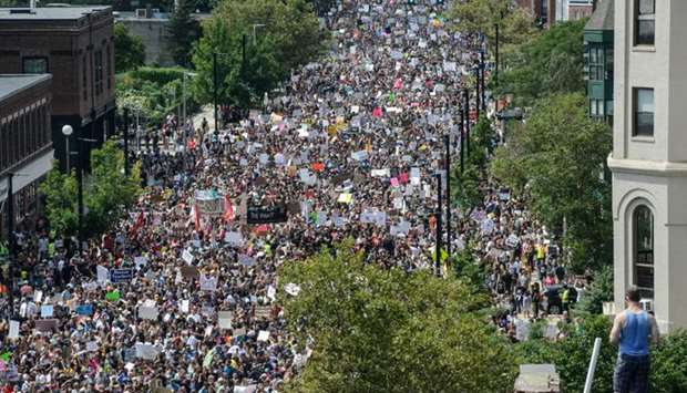 A large crowd of people march towards the Boston Commons to protest the Boston Free Speech Rally in Boston.