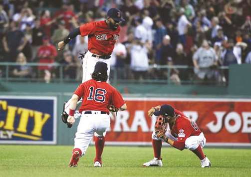 Boston Red Soxu2019s Andrew Benintendi, Jackie Bradley Jr. (top) and Mookie Betts (right) celebrate their win over the New York Yankees at Fenway Park in Boston, Massachusetts, on Friday. (USA TODAY Sports)