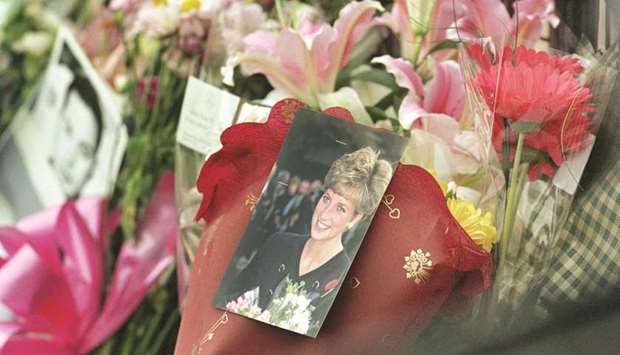 This file photo taken on August 31, 1997 shows tributes placed by the gates of Buckingham Palace in London after it was announced that Diana, Princess of Wales, died in Paris after a car crash.
