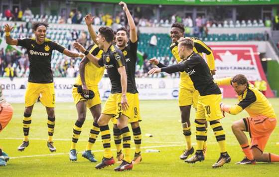 Dortmund players celebrate victory with their fans after the Bundesliga match against Wolfsburg in Wolfsburg, western Germany, yesterday.