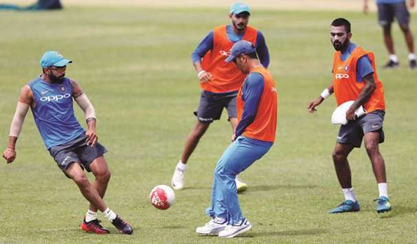 Indian cricket captain Virat Kohli (left) plays football with teammates MS Dhoni and Lokesh Rahul during a practice session in Dambulla, Sri Lanka, on Friday. (Reuters)