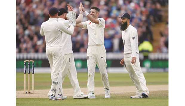 Englandu2019s James Anderson (centre) celebrates the wicket of West Indiesu2019 Kieran Powell with teammates yesterday. (Reuters)