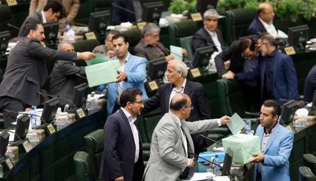 Members of Iran parliament cast their vote in Tehran