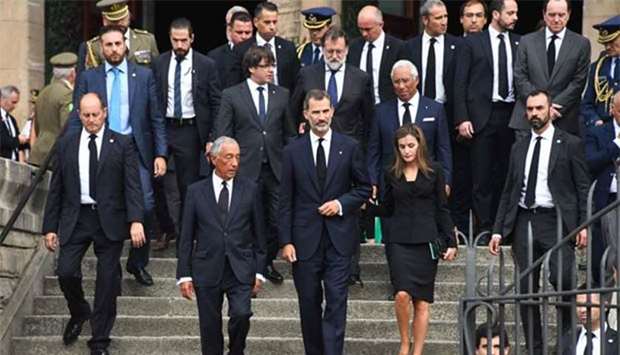 Spain's King Felipe (centre), Queen Letizia (right) and Portugal's President Marcelo Rebelo de Sousa (left) leave after a mass to commemorate victims of two devastating terror attacks in Barcelona and Cambrils, at the Sagrada Familia church in Barcelona on Sunday.