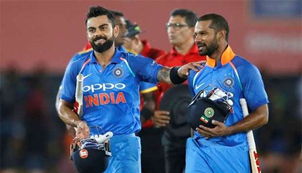 India's captain Virat Kohli and Shikhar Dhawan celebrate victory.