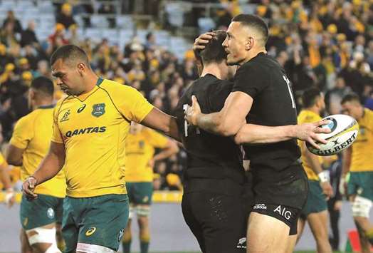 All Blacks players Ben Smith and Sonny Bill Williams celebrate after scoring a try as Wallabiesu2019 Kurtley Beale (left) reacts during their match in Sydney on Saturday. (Reuters)