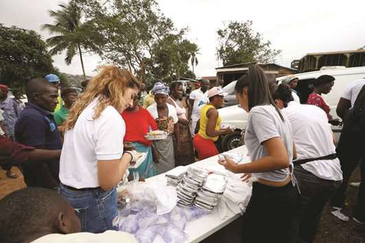 A non-governmental organisation (NGO) is seen distributing meals to victims of the mudslide at the internally displaced persons camp in Regent.