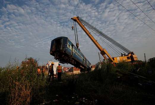 A damaged coach of the passenger train is removed from the site of the accident in Khatauli, yesterday.