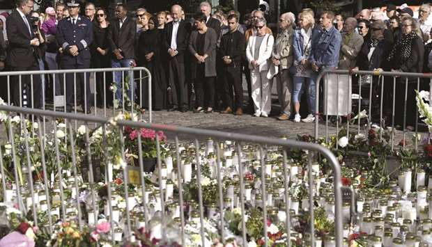 People attend a moment of silence yesterday to commemorate the  victims of Fridayu2019s stabbings at the Turku Market Square in Turku, Finland.