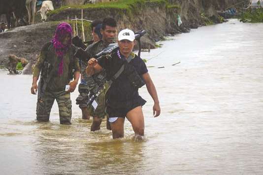 Members of Moro Islamic Liberation Front (MILF) crossing a river in Maguindanao.