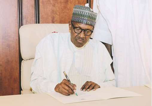 Nigerian President Muhammadu Buhari writes a note to the National Assembly, notifying the legislature of his return to office, after returning to Abuja from a medical vacation.