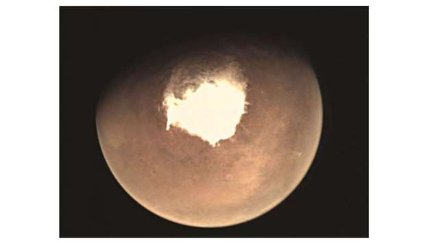 This file handout picture released by the European Space Agency (ESA) shows planet Mars as seen by the webcam on ESAu2019s Mars Express orbiter. Mars is buffeted by turbulent snowstorms that occur only at night, according to a study released yesterday, that revises our understanding of Red Planet weather. Up to now, it was thought that snow falling from low-lying Martian clouds settled slowly and sparsely to the ground in a environment bereft of violent winds.