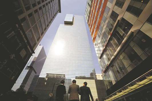 People walk past the building of Samsung Electronics in Seoul. South Korean government has asked the nationu2019s top 129 companies to pay 25% of corporate income tax from 2018, up from the current 22%, on taxable income of more than 200bn won ($179mn) a year.