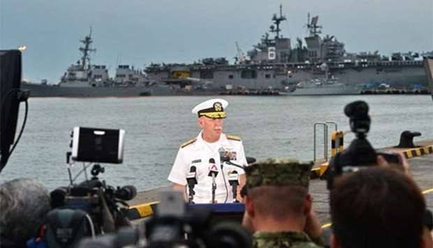 Admiral Scott Swift, commander of the US Pacific Fleet, speaks to reporters during a press conference, as the guided-missile destroyer USS John S. McCain is seen in the background, at Changi naval base in Singapore on Tuesday.