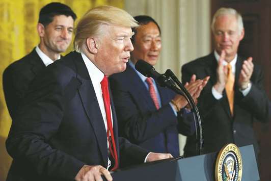 US President Donald Trump (left), flanked by House Speaker Paul Ryan, Foxconn chairman Terry Gou and Senator Ron Johnson in Washington (file). Gou is  considering tripling his US investment budget to $30bn, Trump said while outlining u201coff-recordu201d remarks made by the billionaire founder of Appleu2019s biggest manufacturing partner.