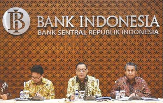 Bank Indonesia governor Agus Martowardojo (centre) along with senior deputy governor Mirza Adityaswara (left) and deputy governor Perry Warjiyo attend a news conference at the banku2019s headquarters in Jakarta yesterday. BI cut the 7-day reverse repurchase rate to 4.50% and lowered two other main policy rates.