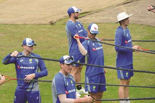 Australiau2019s cricket captain Steven Smith (L) stretches during a training session at the Sher-e-Bangla National Cricket Stadium in Dhaka.