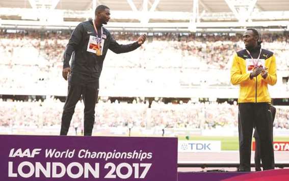World 100m champion Justin Gatlin (L) speaks to bronze medallist Usain Bolt during the medal ceremony at the recent IAAF World Championships in London.