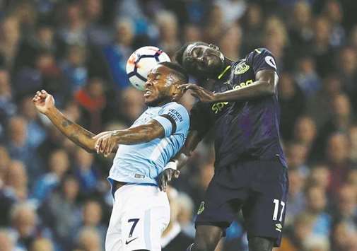 Manchester Cityu2019s Raheem Sterling (left) and Evertonu2019s Idrissa Gueye go for a header during the Premier League match at the Ethiad stadium in Manchester, Britain, on Monday night. (Reuters)
