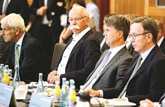 From left: Matthias Wissmann, president of the German Automobile Industry Association (VDA); Harald Krueger, CEO of BMW; Dieter Zetsche, chairman of Daimler and head of Mercedes-Benz cars; and Matthias Mueller, CEO of Volkswagen; attend a so-called u2018diesel summitu2019 in Berlin yesterday. The VDA said its members had agreed to pay for software updates of 5mn cars, including 2.5mn VW cars that have already been recalled, to reduce their average emissions of toxic nitrogen oxides by 25-30%.
