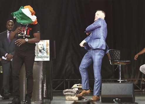 In this July 12, 2017, picture, Conor McGregor (right) throws an Irish flag at Floyd Mayweather as he speaks during a press conference in Toronto. (USA TODAY Sports)