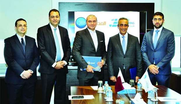 Gamal and Hadid with the executives of QIB and AlJaber Engineering after finalising the QR1.6bn financing deal.
