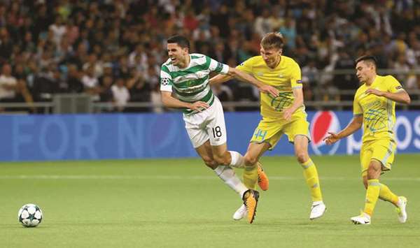 Celticu2019s Tom Rogic (left) is fouled by FC Astanau2019s Yevgeny Postnikov during the Champions League play-offs in Astana, Kazakhstan, yesterday. (Reuters)