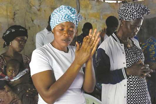 Locals attend a mass celebrated at the Royal Kings International school in Freetown on Sunday.