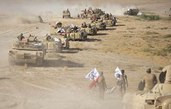 Iraqi troops march on the the outskirts of Tal Afar.