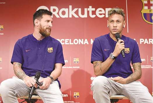 File picture of Barcelona striker Neymar (R) answers questions beside his teammate Lionel Messi (L) in Tokyo.