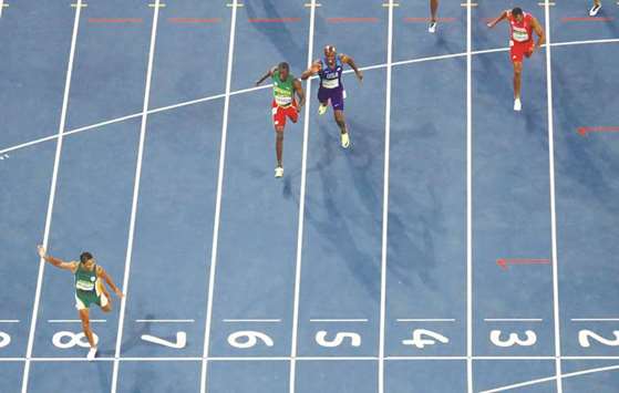 In this August 14, 2016, picture, Wayde van Niekerk (left) of South Africa crosses the finish line to win menu2019s 400m gold and set a new world record at the 2016 Olympic Games in Rio de Janeiro, Brazil. (Reuters)
