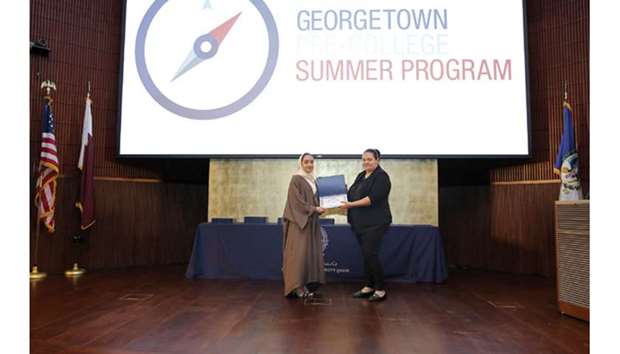 A participant gets a certificate of participation at the Georgetown Pre-College Summer programmeu2019s closing ceremony.
