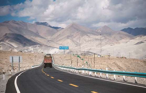 This picture taken on June 27, 2017 shows a truck driving along the China-Pakistan Friendship Highway before the Karakorum mountain range near Tashkurgan in Chinau2019s western Xinjiang province.