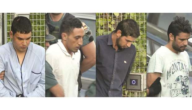 This combination of pictures created yesterday shows (from left) Mohamed Houli Chemlal, Driss Oukabir, Salh El-Karib, and Mohamed Aallaa, suspected of involvement in the terror cell that carried out twin attacks in Barcelona and Cambrils, escorted by Spanish Civil Guards from a detention centre in Tres Cantos, near Madrid, before being transferred to the National Court.
