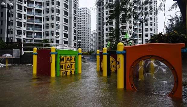 A flooded playground is seen in front of residential blocks after heavy rains caused by Typhoon Hato swept Hong Kong on Wednesday.